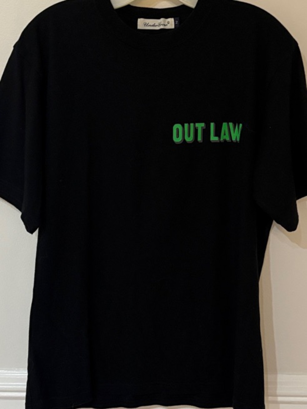 Undercover Black Tee with Green OUT LAW Chest Graphic